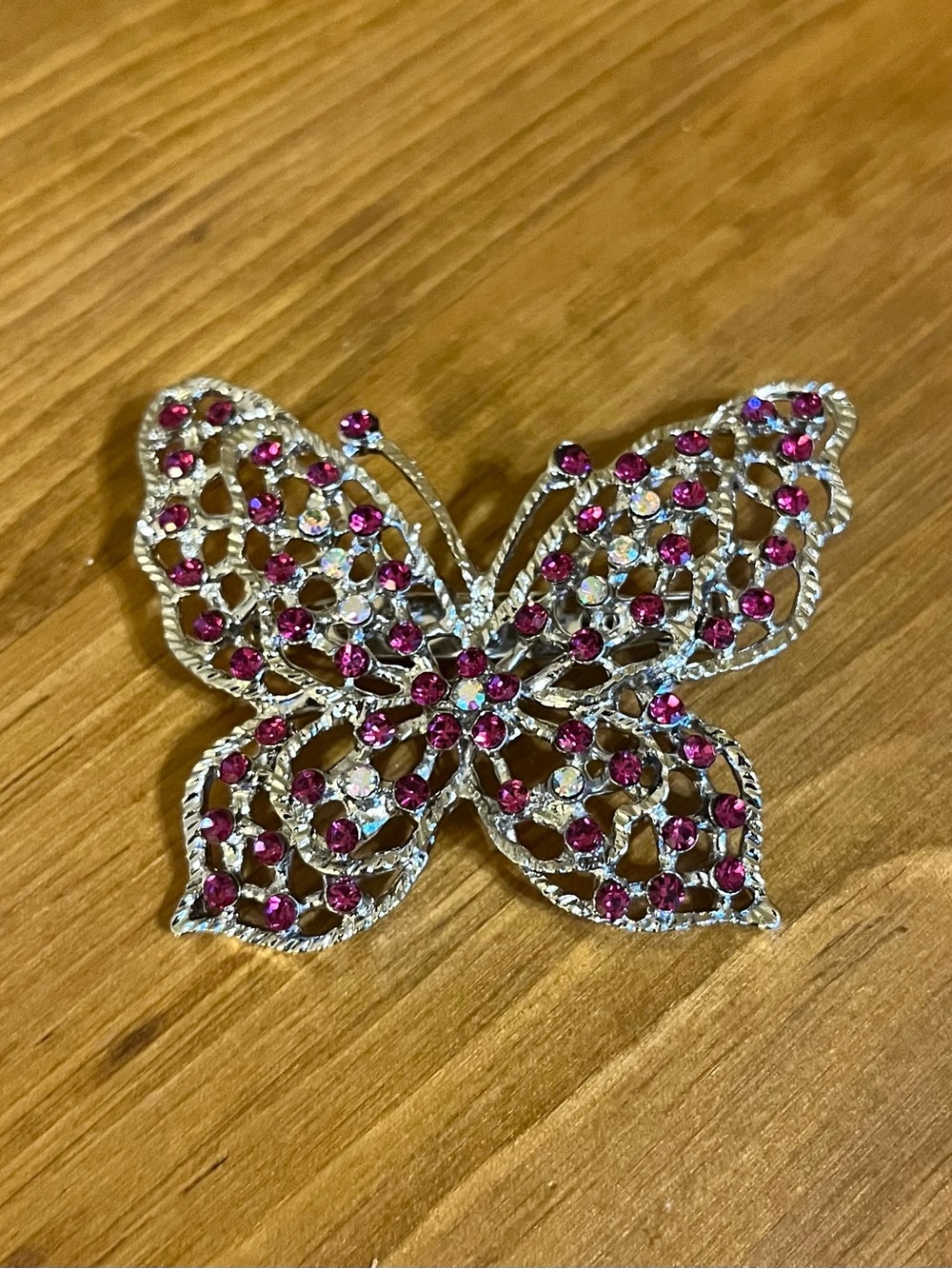 Butterfly with cranberry red & ab rhinestones on silver filigree brooch 2 1/4”